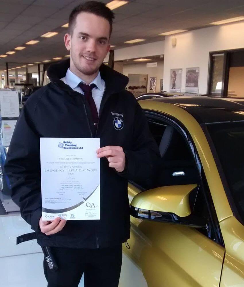 client proudly holding his certificate